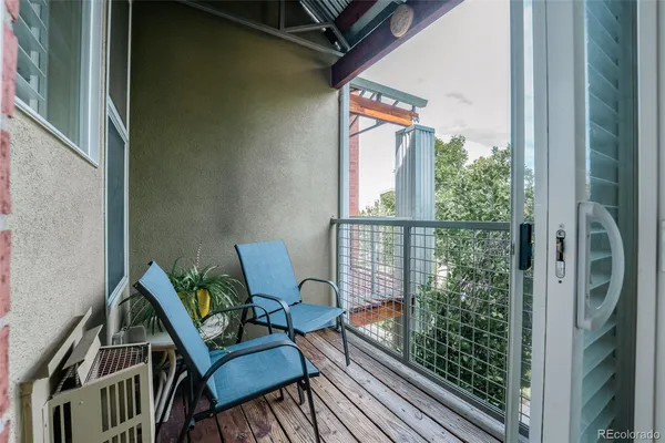 a view of a balcony with furniture