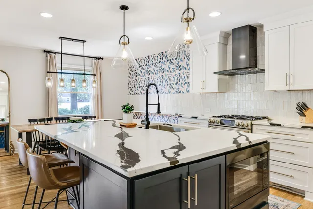 a kitchen with stainless steel appliances white cabinets and a sink