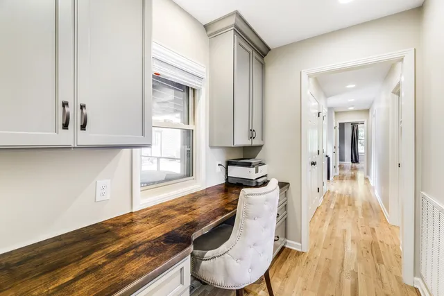 a view of a patio with table and chairs potted plants and large tree