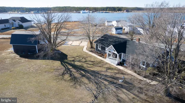 a living room with stainless steel appliances kitchen island furniture and a view of kitchen