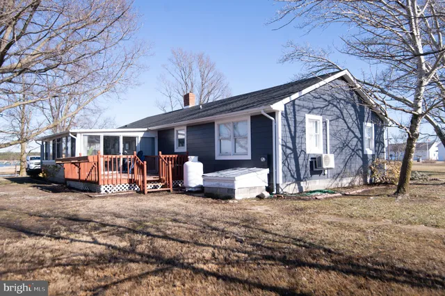 a kitchen with a dining table chairs and white cabinets