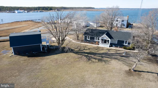 a front view of a house with a yard covered with snow in front of it