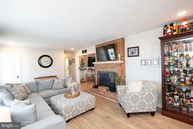 a view of a dining room with furniture a chandelier and wooden floor