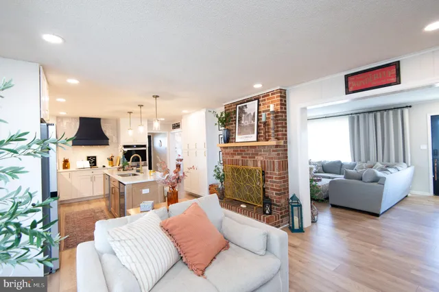 a dining room with wooden floor table and chairs