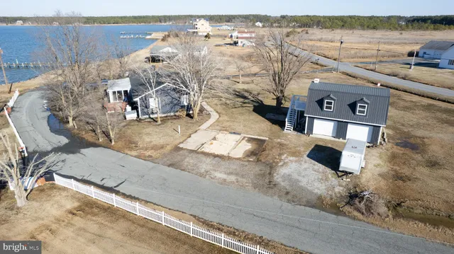 a view of a house with large space and a car parked in front of it