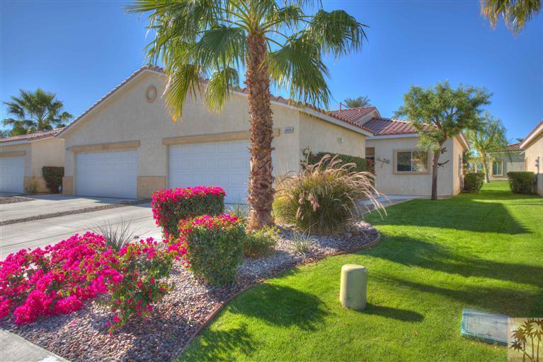 a front view of house with yard and swimming pool
