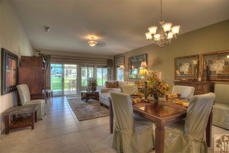49121 Biery Street Indio, CA 92201 - Photo 11 of 25 a view of a dining room with furniture a chandelier and large windows