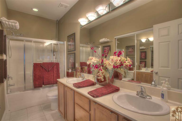 49121 Biery Street Indio, CA 92201 - Photo 17 of 25 a bathroom with a sink vanity granite tub shower and a mirror