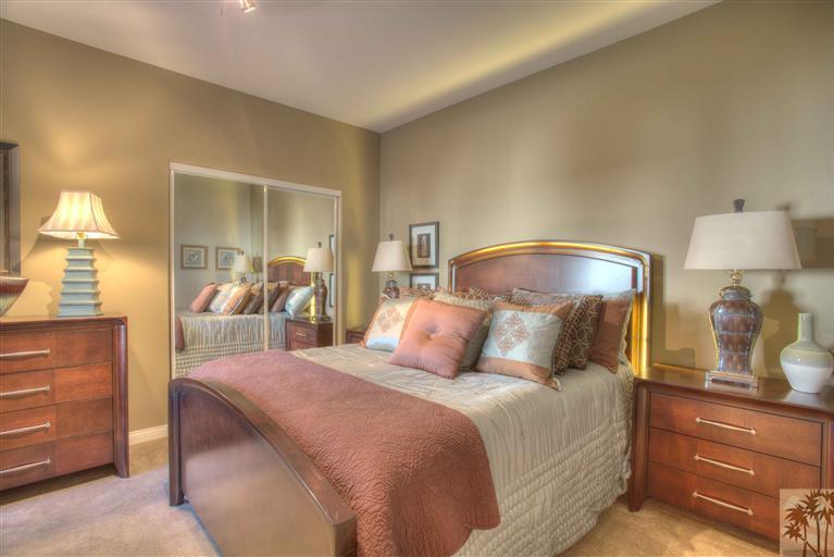 49121 Biery Street Indio, CA 92201 - Photo 19 of 25 a bedroom with a bed and a mirror