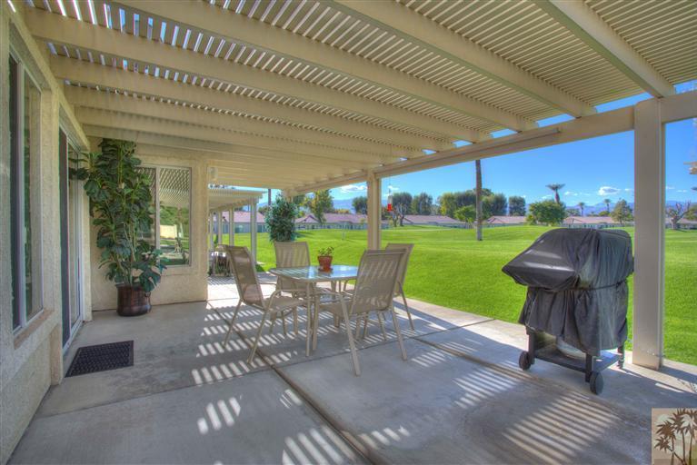 49121 Biery Street Indio, CA 92201 - Photo 20 of 25 a view of a patio with table and chairs potted plants with wooden floor