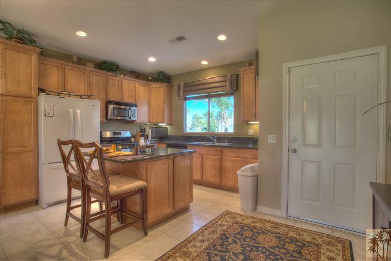 49121 Biery Street Indio, CA 92201 - Photo 6 of 25 a kitchen with stainless steel appliances granite countertop a refrigerator and a stove top oven