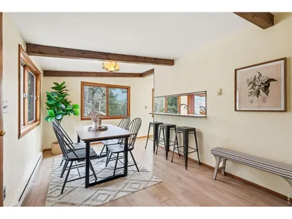 a dining room with furniture and wooden floor