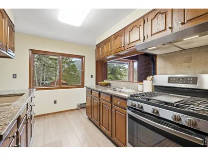 a kitchen with stainless steel appliances granite countertop a stove and a sink