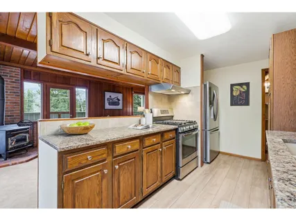 a kitchen with stainless steel appliances granite countertop a sink and cabinets
