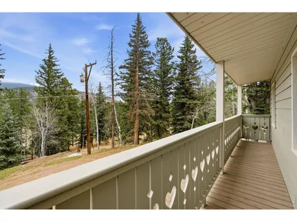 a view of balcony with wooden floor and fence