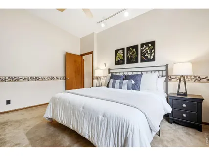 a bedroom with a bed and a night stand