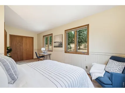 a bedroom with a large bed and a window