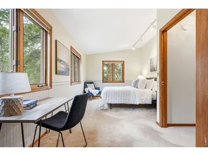 a bedroom with a bed a table and chair