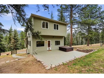 a view of a house with backyard and sitting area