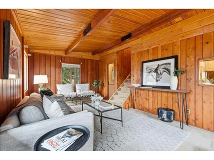 a living room with furniture a rug and a large window