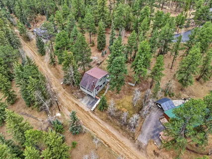an aerial view of a house with a yard