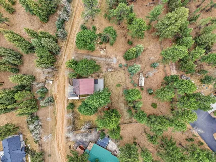 an aerial view of a house with yard