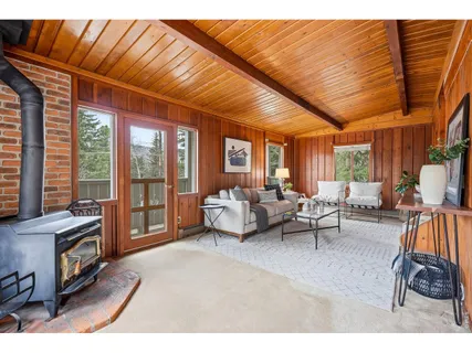 a living room with furniture and a floor to ceiling window