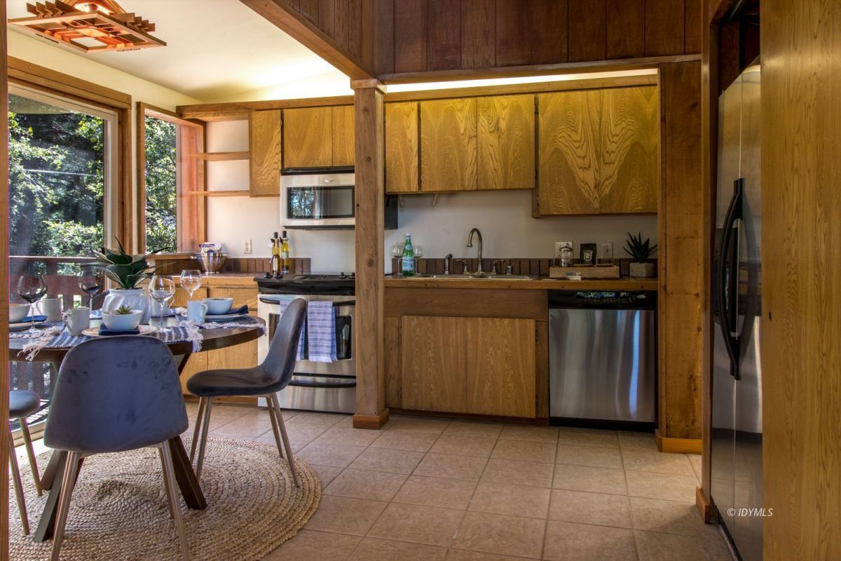 25281 Deer Path Road Pine Cove, CA 92549 - Photo 19 of 42 a view of a kitchen with kitchen island granite countertop wooden cabinets and a stainless steel appliances