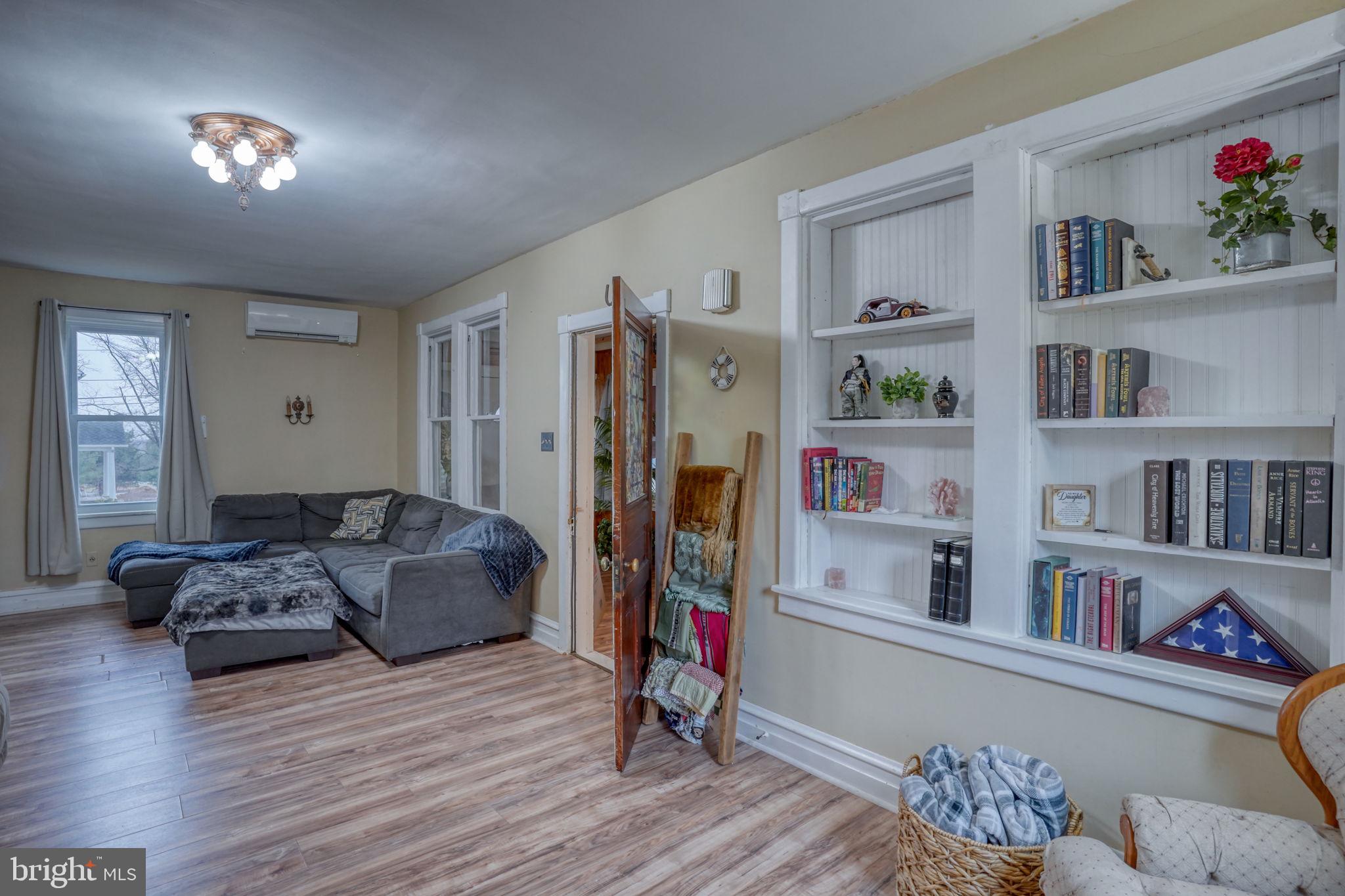 7 Patterson Avenue Perryville, MD 21903 - Photo 2 of 44 a living room with furniture and a book shelf