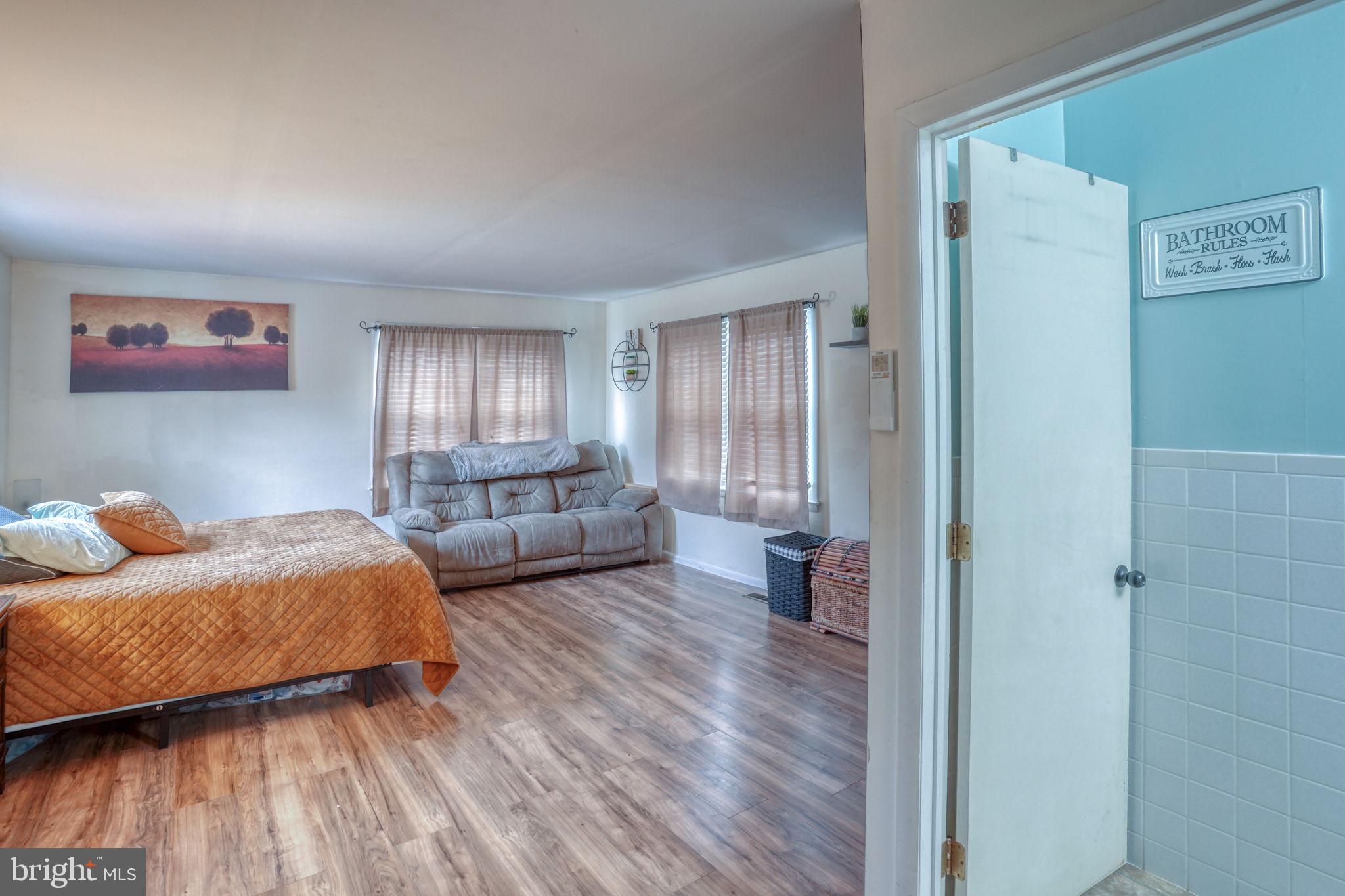 7 Patterson Avenue Perryville, MD 21903 - Photo 23 of 44 a bedroom with furniture and wooden floor