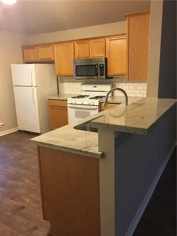 a kitchen with a sink a stove and a refrigerator