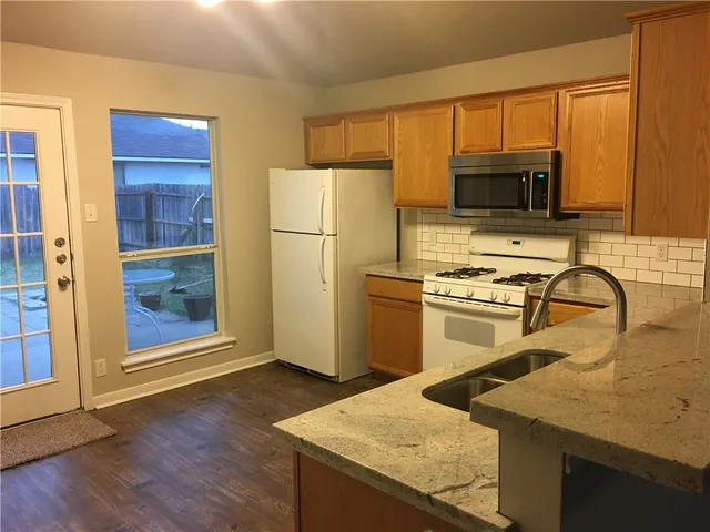 a kitchen with a sink a stove and refrigerator
