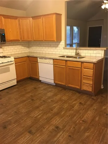 a kitchen with a sink cabinets and window