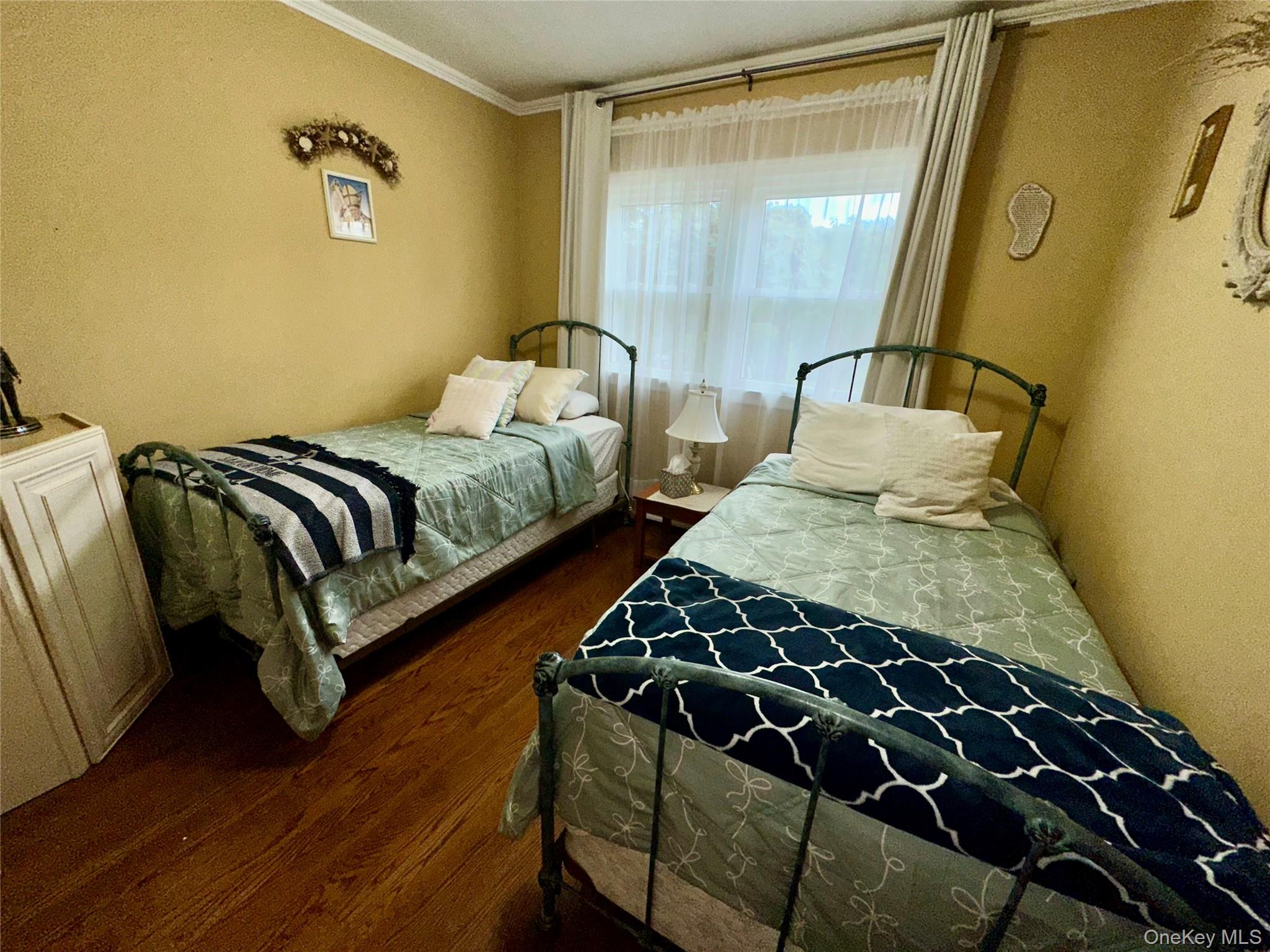 406 Moriches Road St. James, NY 11780 - Photo 16 of 28 a bedroom with a bed and wooden floor