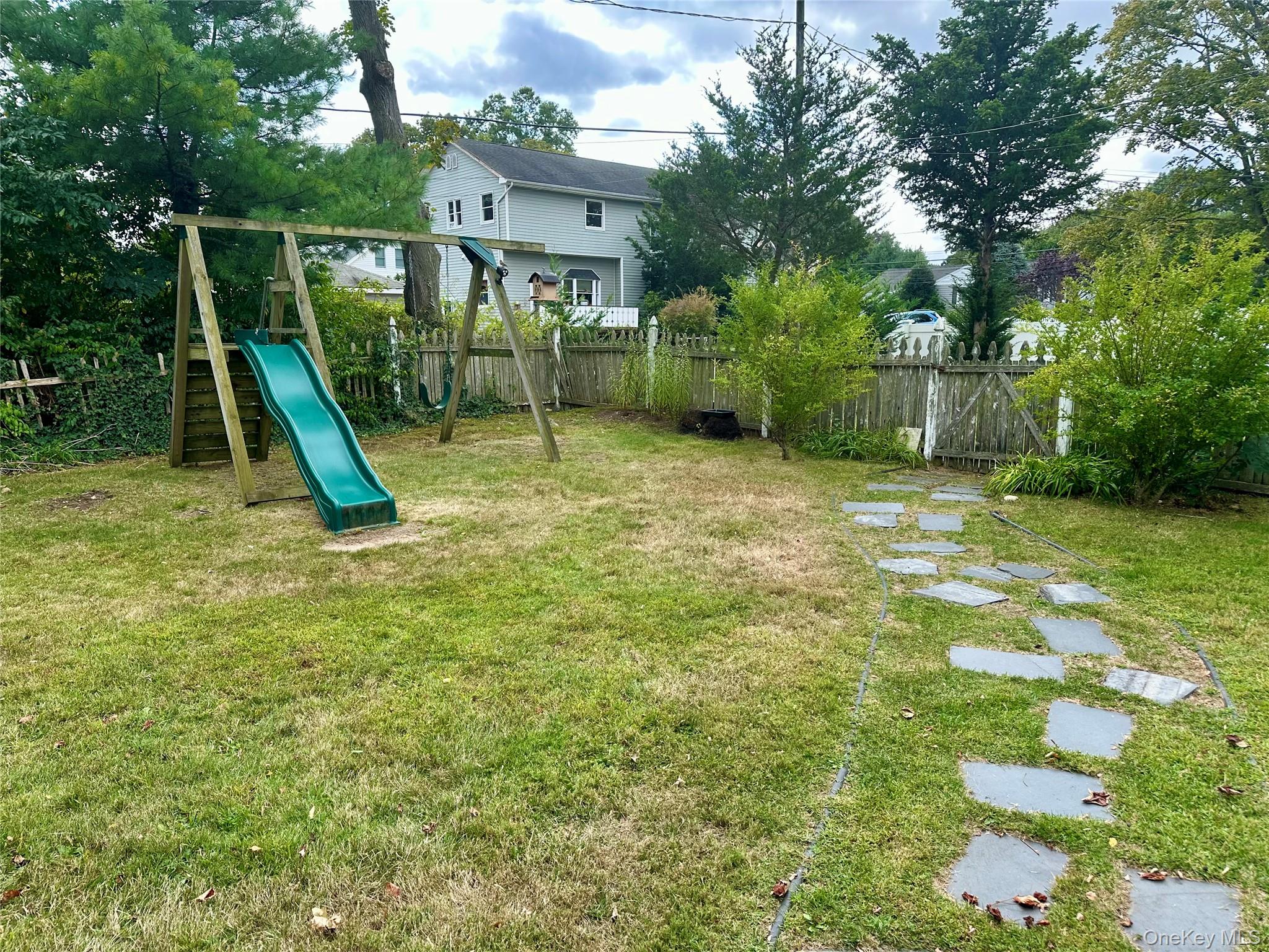 406 Moriches Road St. James, NY 11780 - Photo 22 of 28 a view of a garden with a slide