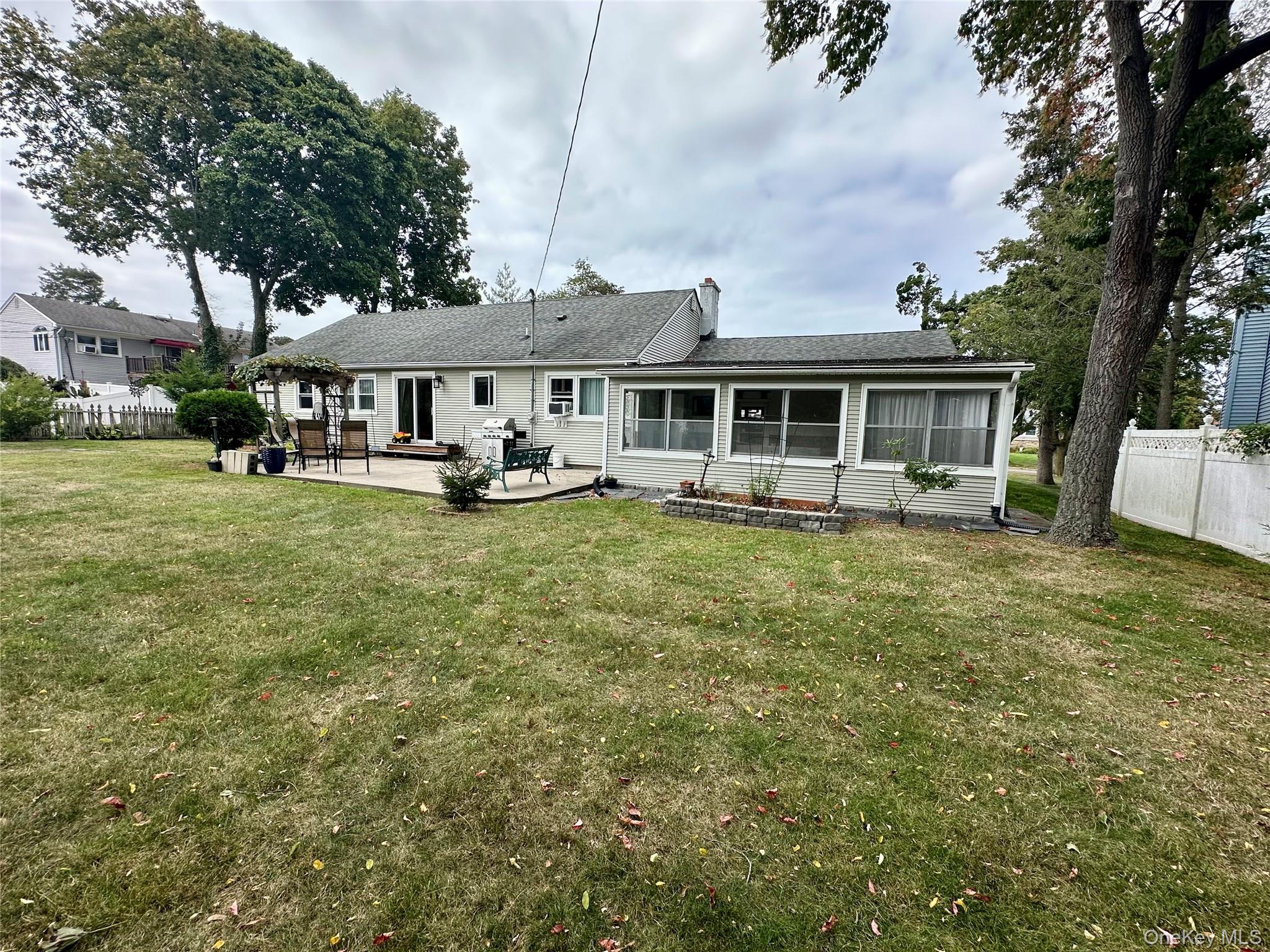 406 Moriches Road St. James, NY 11780 - Photo 23 of 28 a view of a house with backyard porch and sitting area