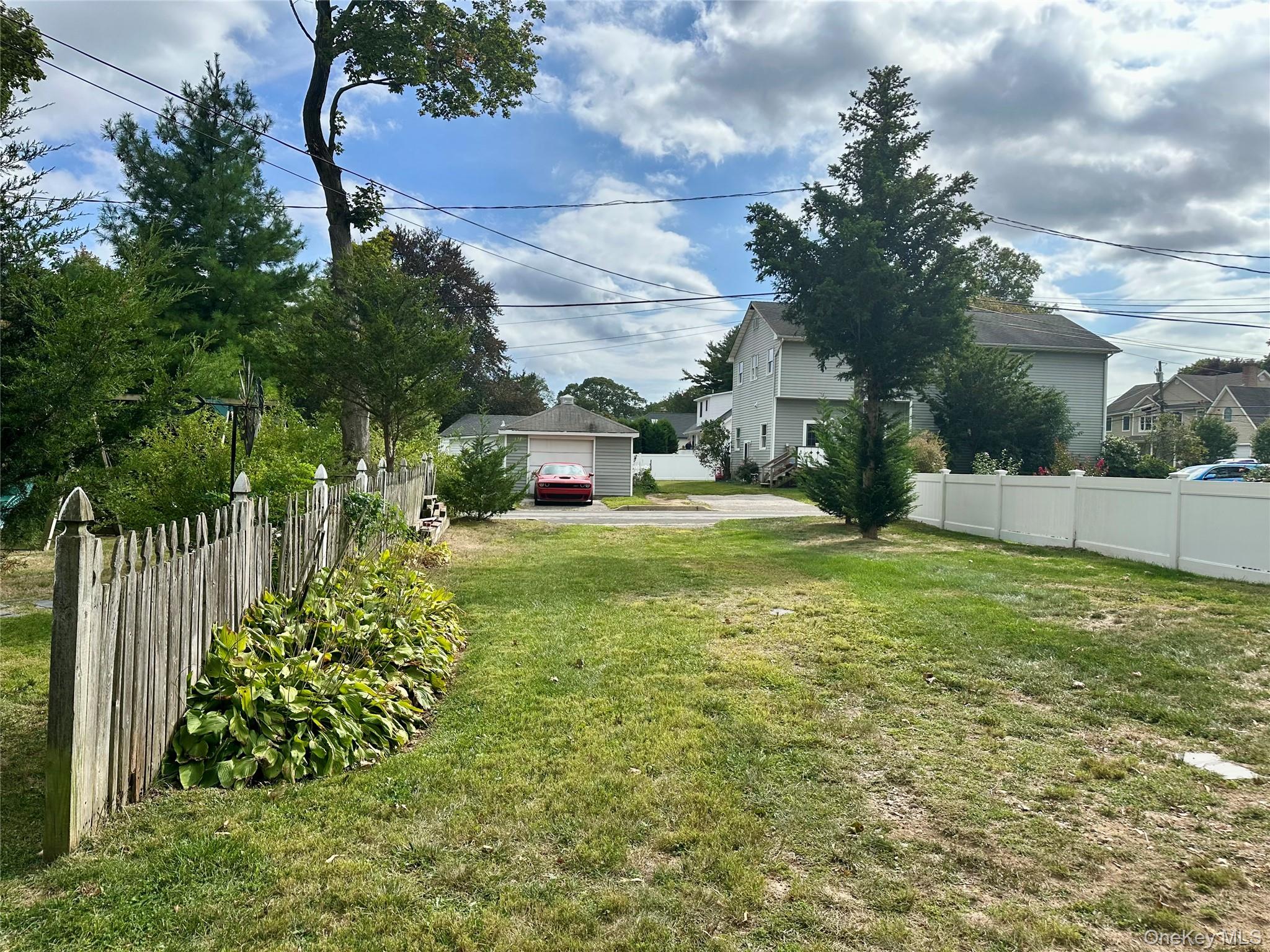 406 Moriches Road St. James, NY 11780 - Photo 25 of 28 a view of a garden with a fountain