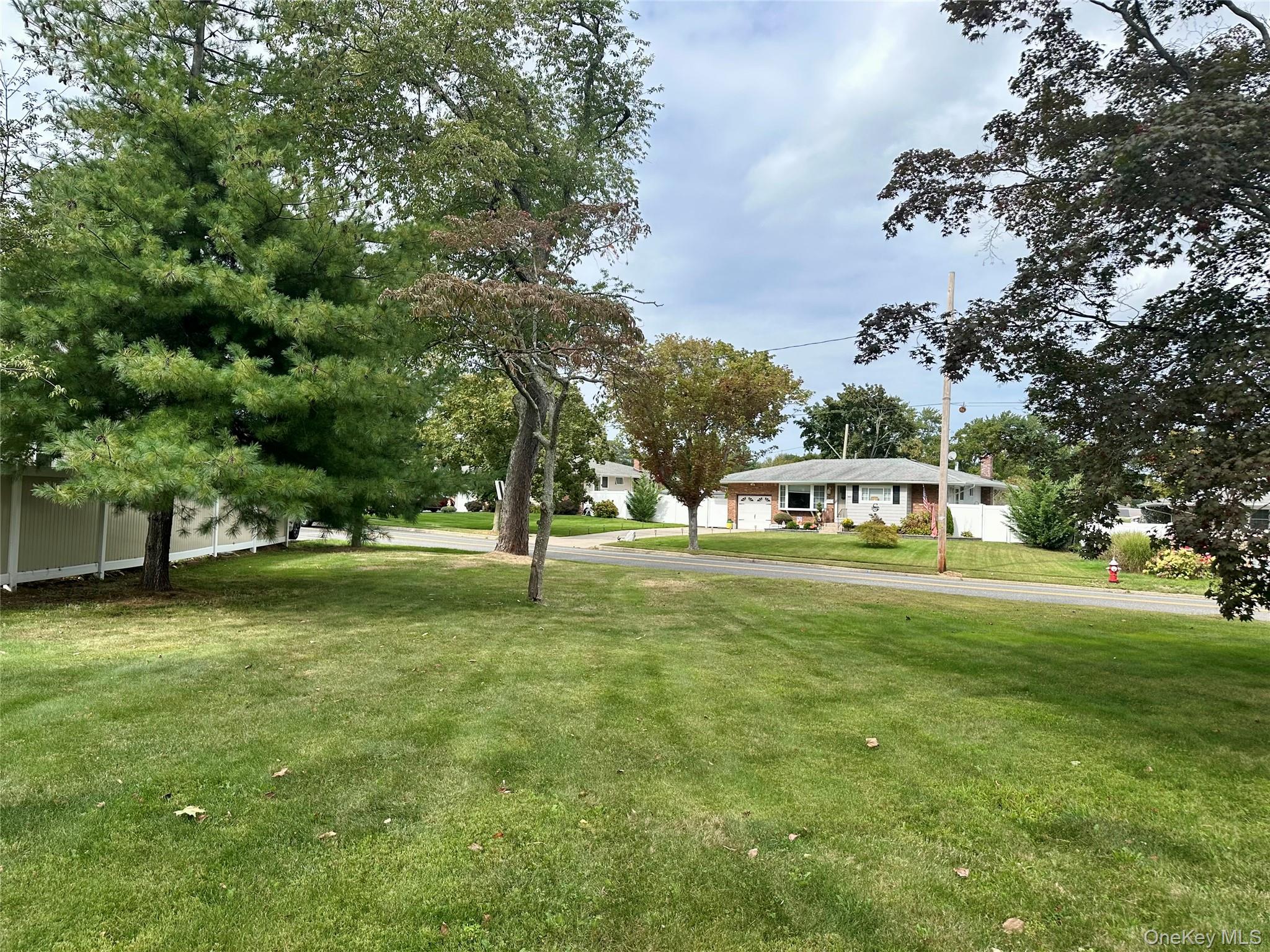 406 Moriches Road St. James, NY 11780 - Photo 26 of 28 a view of a house with a big yard