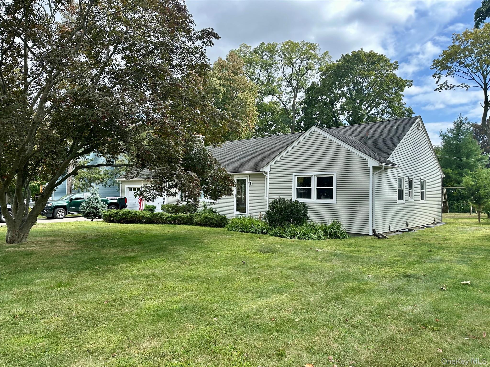 406 Moriches Road St. James, NY 11780 - Photo 28 of 28 a view of a house with a yard
