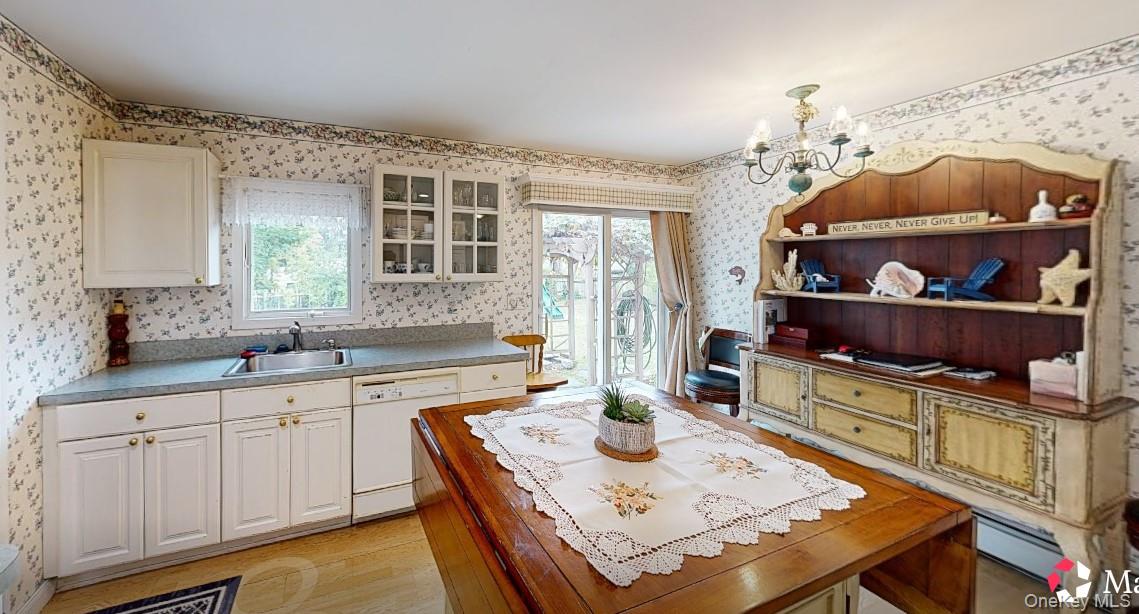 406 Moriches Road St. James, NY 11780 - Photo 4 of 28 a kitchen with a table chairs and cabinets