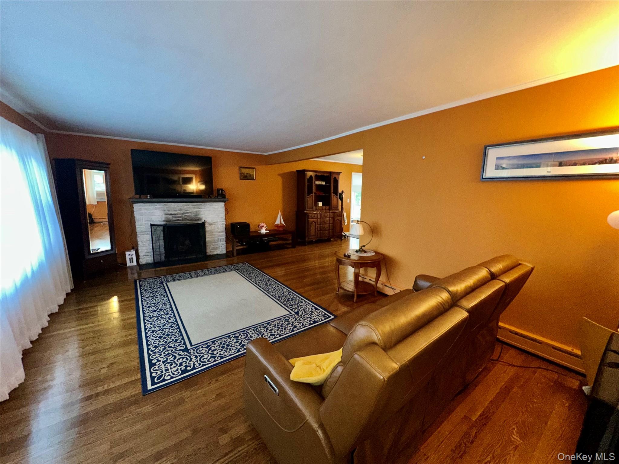 406 Moriches Road St. James, NY 11780 - Photo 7 of 28 a living room with furniture and a fireplace