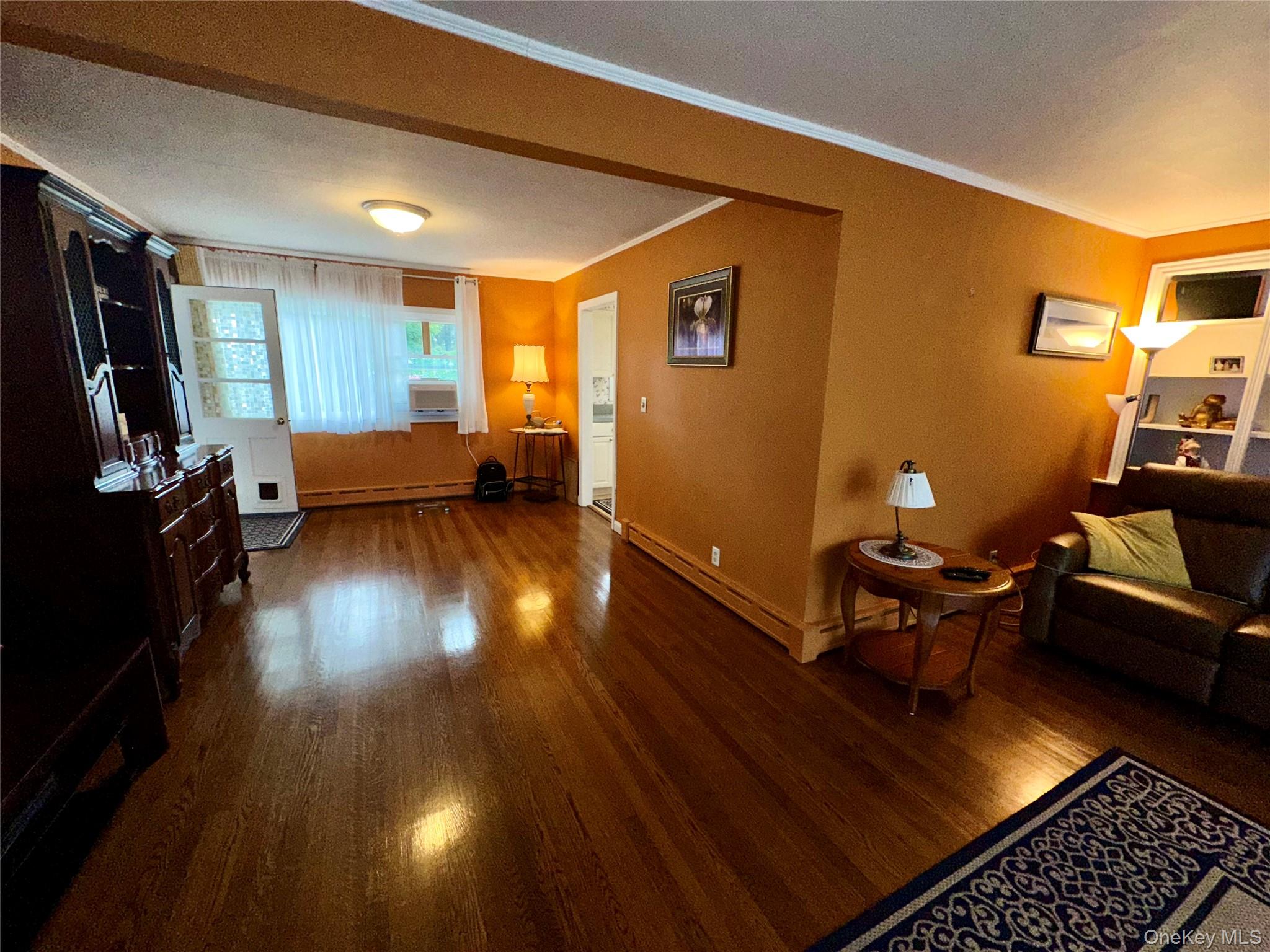 406 Moriches Road St. James, NY 11780 - Photo 9 of 28 a living room with furniture and a wooden floor