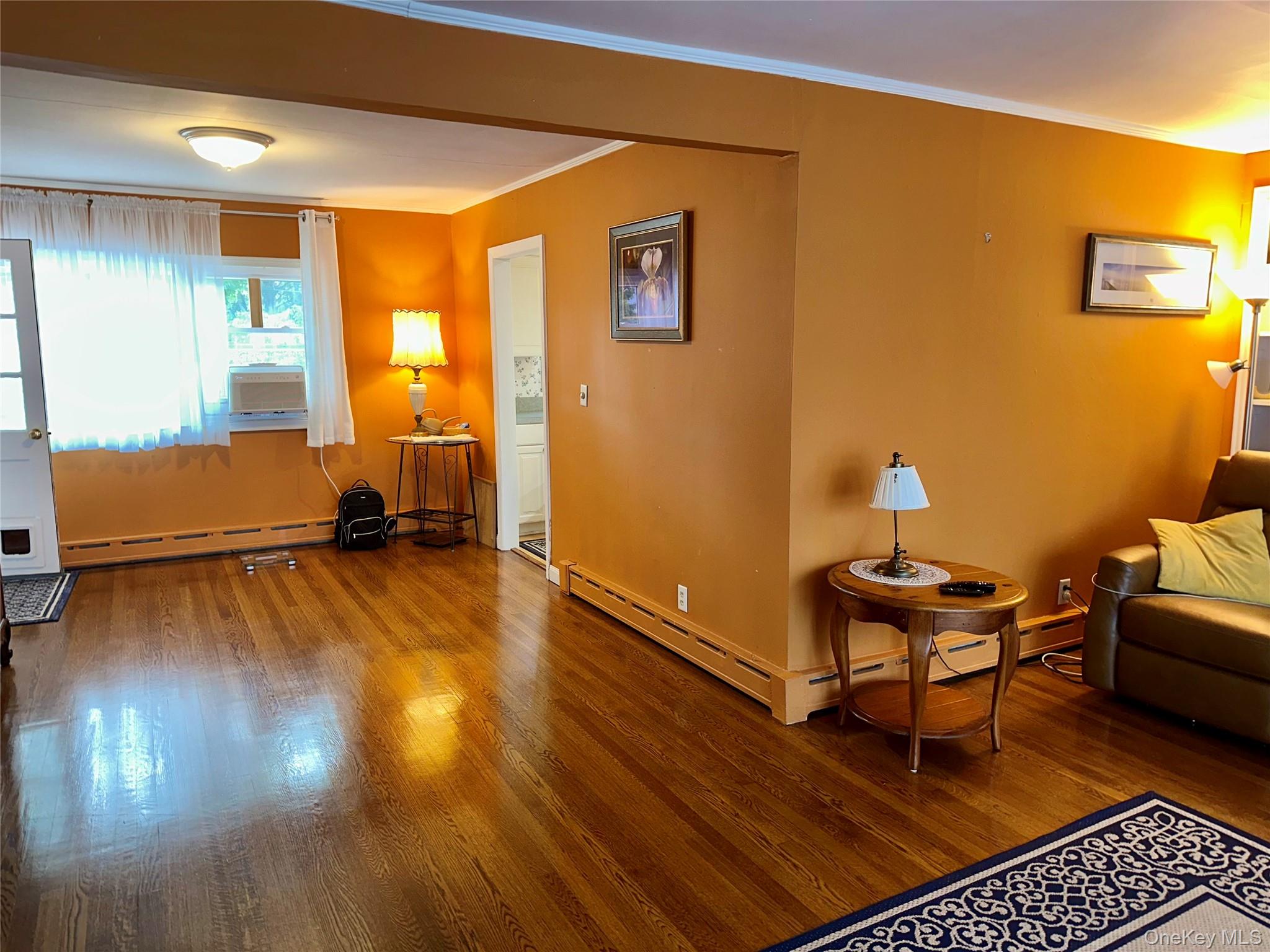 406 Moriches Road St. James, NY 11780 - Photo 10 of 28 a room with wooden floor and furniture
