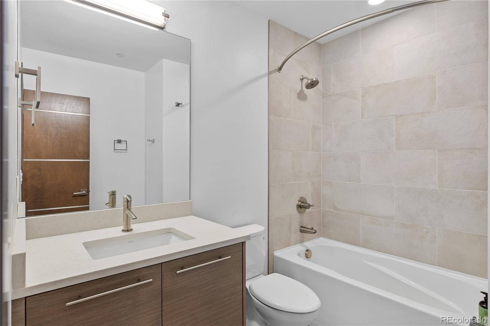 3535 Tejon Street Denver, CO 80211 - Photo 25 of 50 a bathroom with a sink a toilet and shower