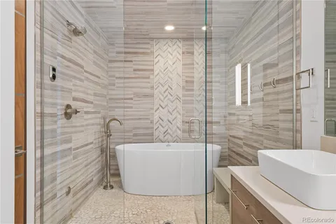 a bathroom with a bathtub and shower