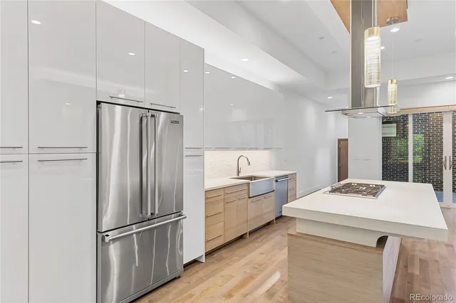 a kitchen with a refrigerator a stove a sink and a refrigerator