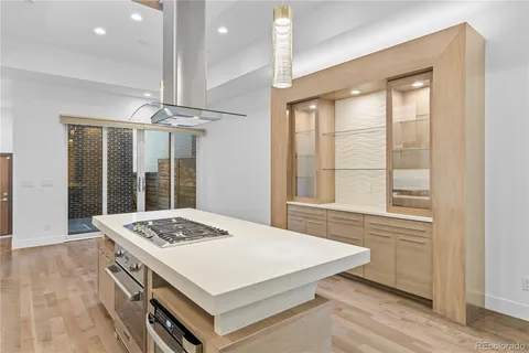 a kitchen that has a stove and a table in it