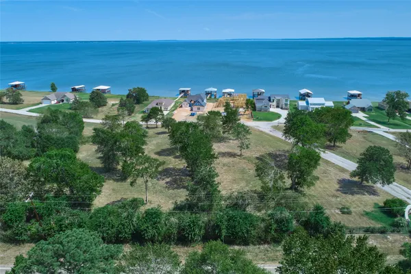 an aerial view of a houses with a yard