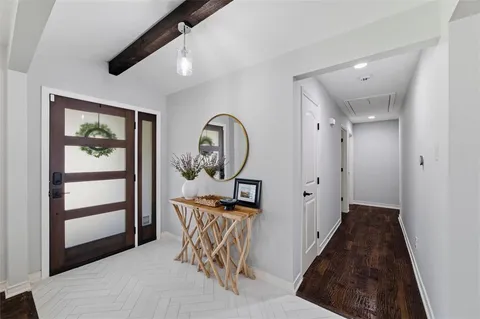a view of a hallway to a livingroom and a dinning room with wooden floor