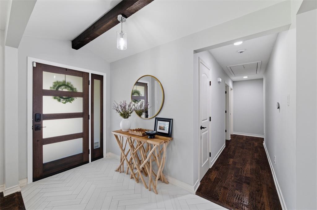 10717 Ferndale Road Dallas, TX 75238 - Photo 2 of 36 a view of a hallway to a livingroom and a dinning room with wooden floor